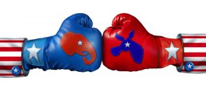 American election campaign fight as Republican Versus Democrat represented by two boxing gloves with the elephant and donkey symbol stitched fighting for the vote of the United states citizens for an election win.